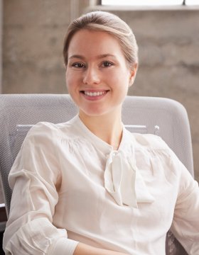 young-white-woman-sitting-at-office-desk-smiling-t-2021-08-26-16-14-58-utc.jpg